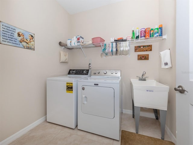 laundry area with light tile patterned floors and washing machine and dryer