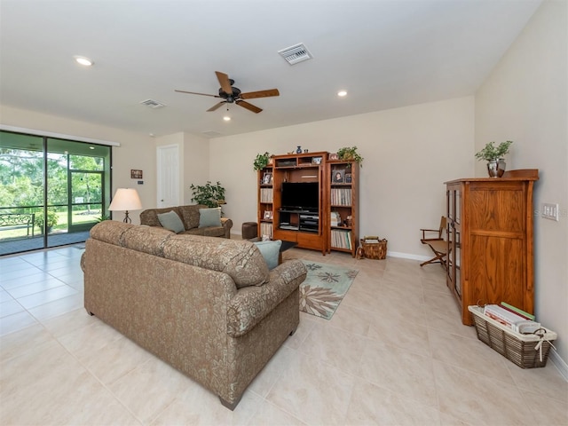 living room with ceiling fan and light tile patterned flooring