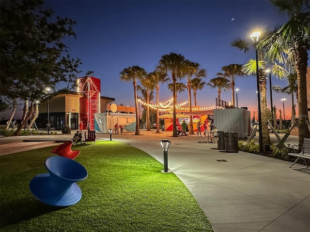 view of community featuring a playground and a lawn