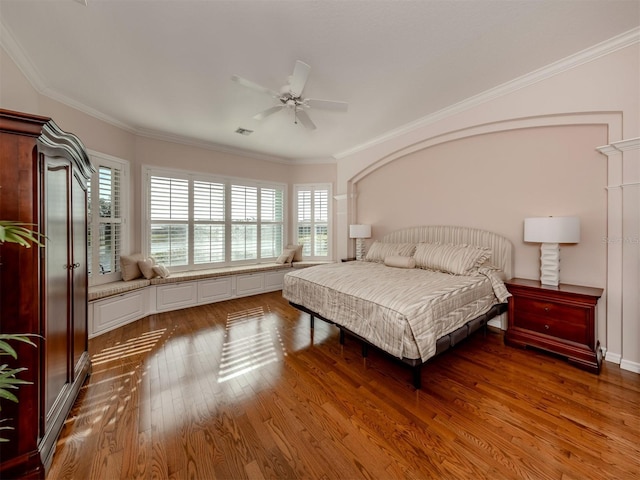 bedroom featuring ornamental molding, dark hardwood / wood-style floors, and ceiling fan