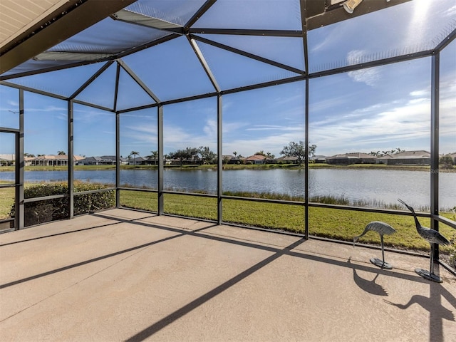 unfurnished sunroom featuring a water view