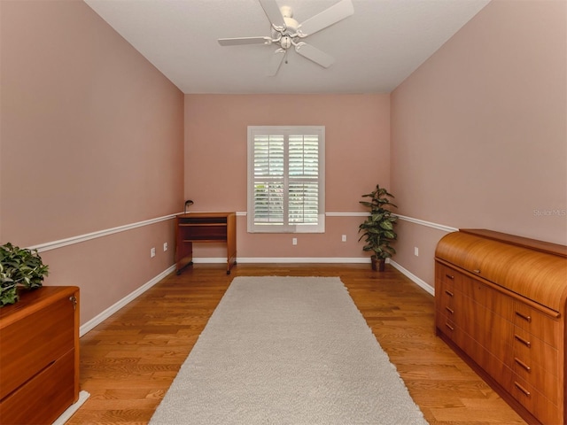 living area with ceiling fan and light hardwood / wood-style floors