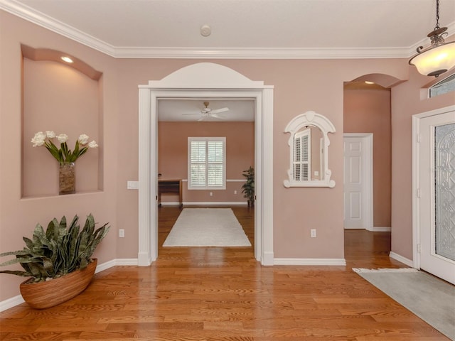 entrance foyer featuring crown molding and light hardwood / wood-style flooring