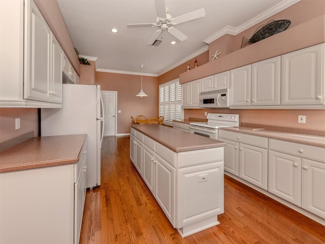 kitchen with white cabinets, hanging light fixtures, white appliances, crown molding, and light wood-type flooring