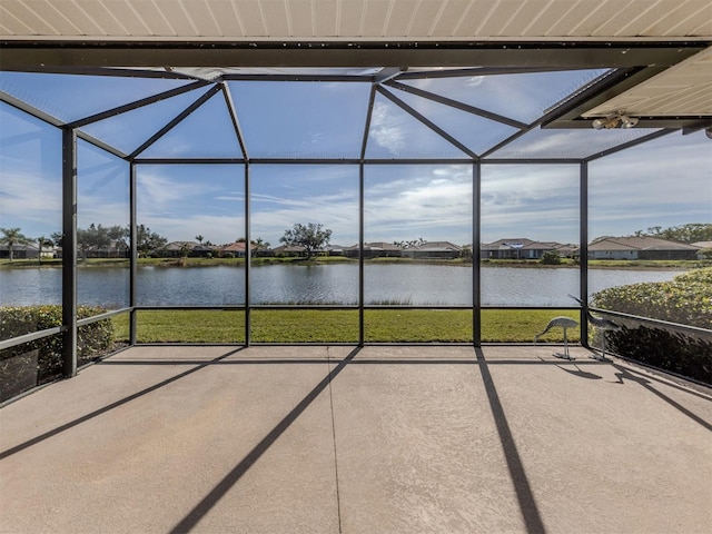 unfurnished sunroom featuring a water view