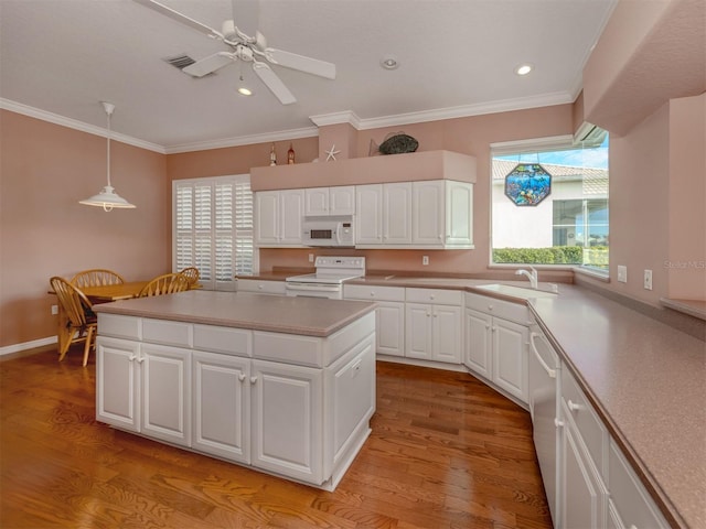 kitchen featuring sink, decorative light fixtures, white appliances, light hardwood / wood-style floors, and white cabinets