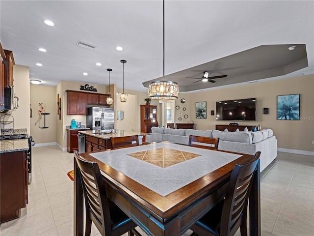 tiled dining room featuring ceiling fan