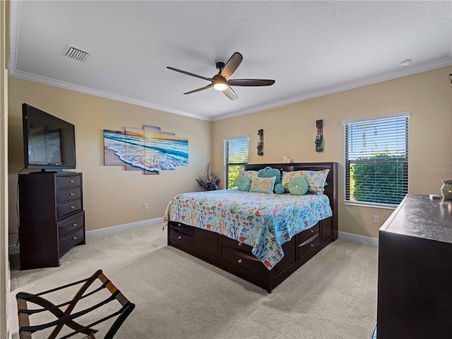 carpeted bedroom featuring crown molding and ceiling fan