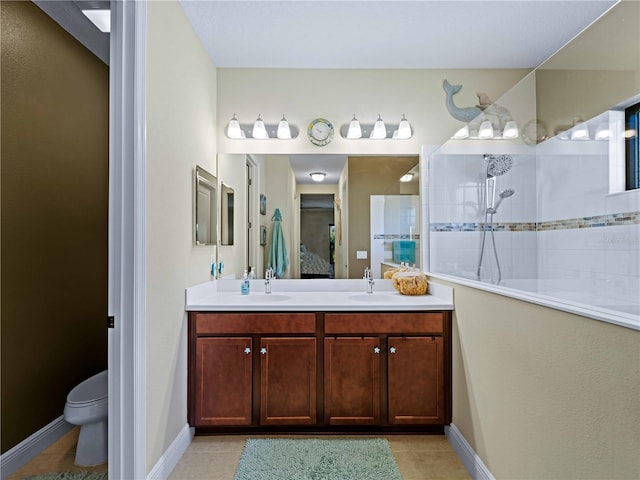 bathroom with tiled shower, tile patterned floors, toilet, and vanity