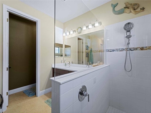 bathroom featuring vanity, tiled shower, and tile patterned floors