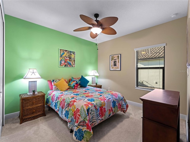 carpeted bedroom with ceiling fan