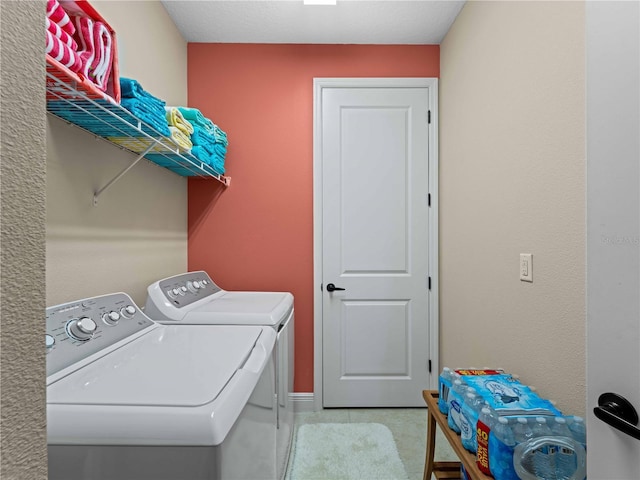 clothes washing area with washing machine and dryer