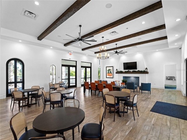 dining space featuring french doors, ceiling fan, light hardwood / wood-style flooring, and beamed ceiling