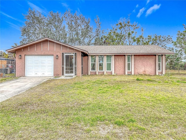 single story home with a garage and a front lawn