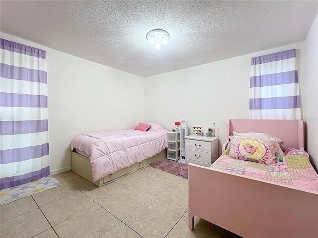 tiled bedroom with a textured ceiling