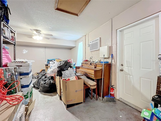 interior space with a wall mounted air conditioner and ceiling fan