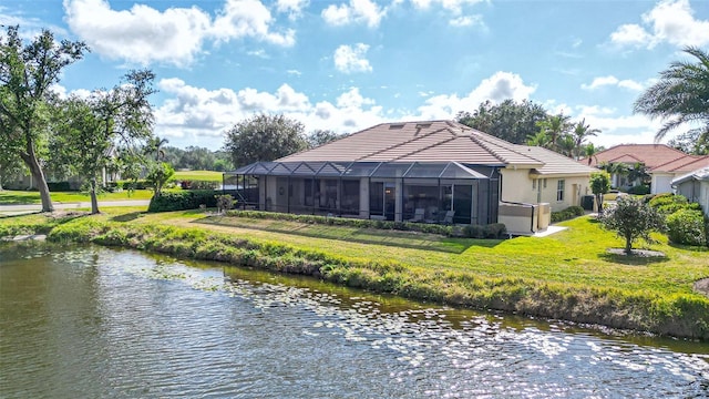 back of house featuring a water view, a lanai, and a yard