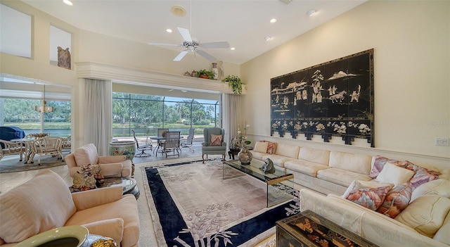 living room featuring ceiling fan and high vaulted ceiling