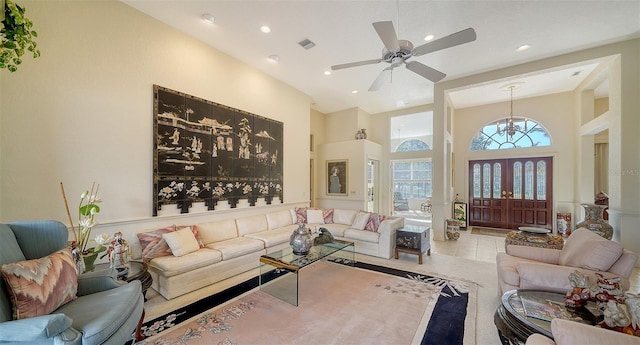 living room featuring a towering ceiling and light tile patterned floors