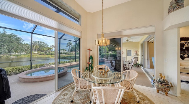 sunroom featuring a water view