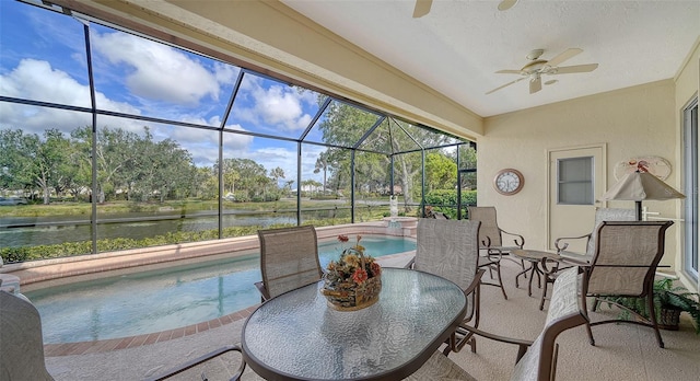 exterior space with a water view and ceiling fan