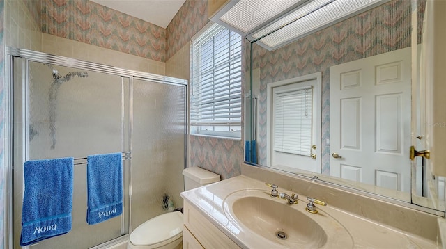 bathroom with vanity, an enclosed shower, and toilet