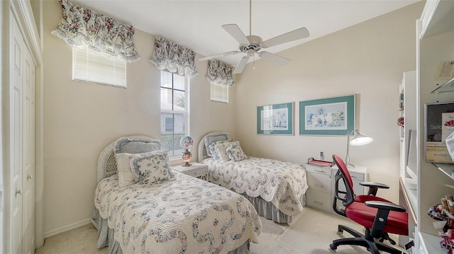 bedroom featuring light colored carpet and ceiling fan