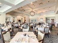 dining room featuring coffered ceiling and beam ceiling