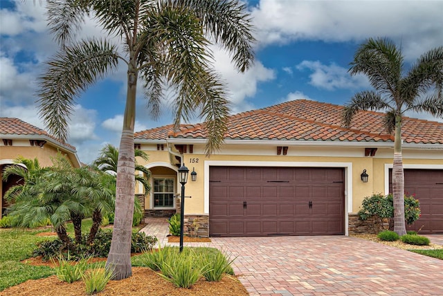 mediterranean / spanish-style house with a garage