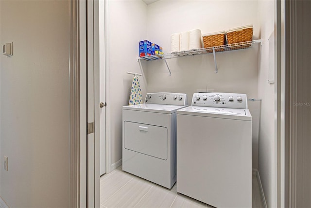 clothes washing area with washer and clothes dryer