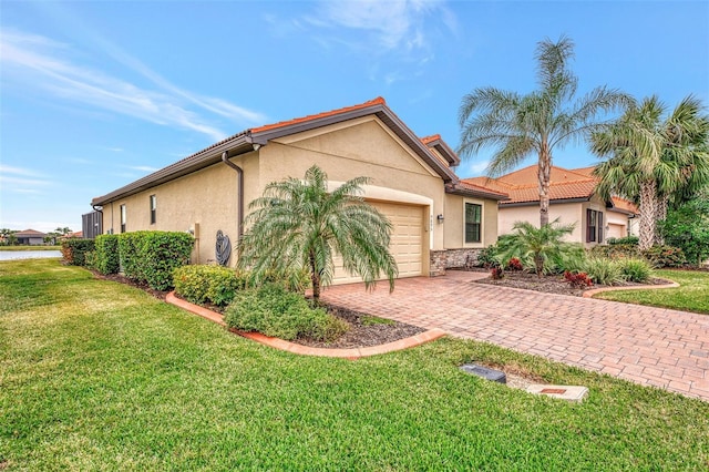 view of front of house featuring a garage and a front lawn