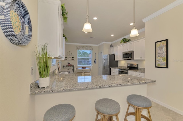 kitchen with appliances with stainless steel finishes, sink, white cabinets, and kitchen peninsula