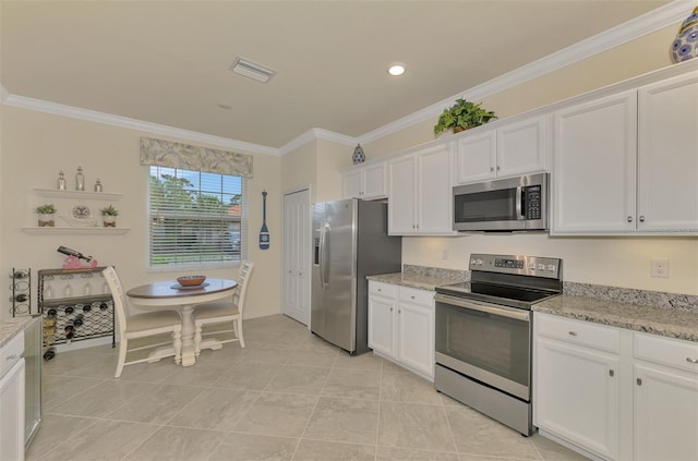 kitchen featuring light tile patterned floors, ornamental molding, appliances with stainless steel finishes, light stone countertops, and white cabinets