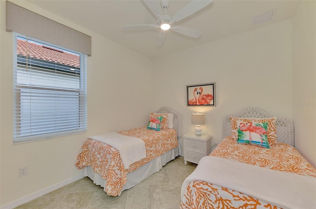 bedroom with light tile patterned floors and ceiling fan