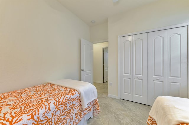 tiled bedroom featuring a closet