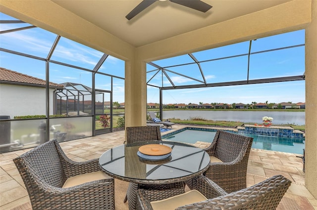 exterior space featuring a water view, a pool with hot tub, and a lanai