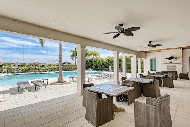 view of patio with ceiling fan and a community pool