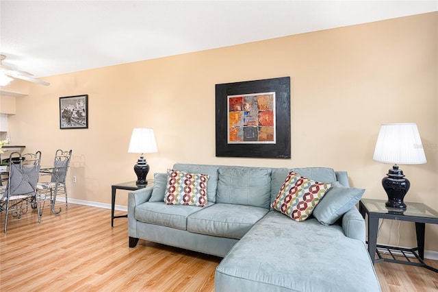 living room with hardwood / wood-style flooring and ceiling fan