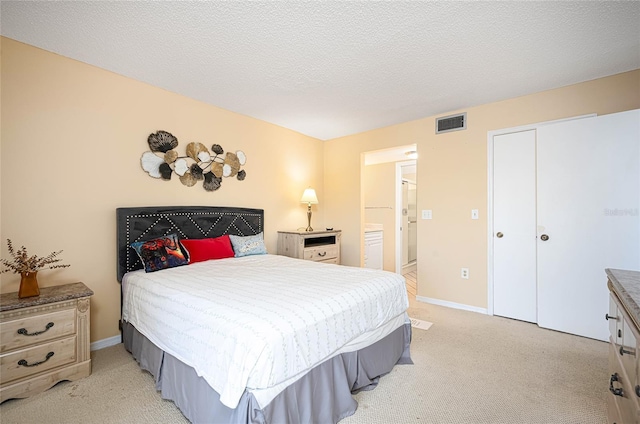 carpeted bedroom with a closet and a textured ceiling