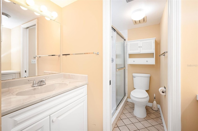 bathroom featuring vanity, a shower with shower door, tile patterned floors, and toilet