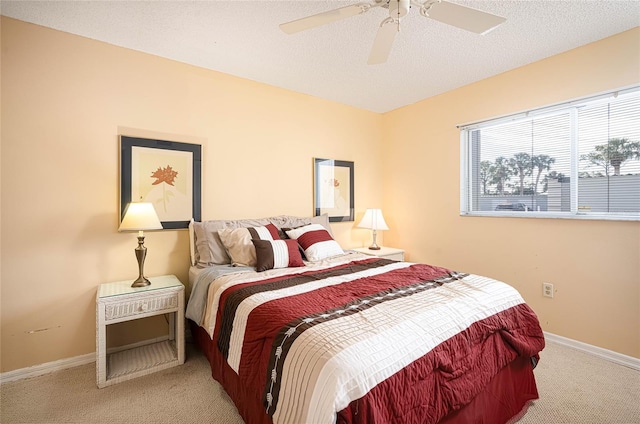 bedroom with light carpet, a textured ceiling, and ceiling fan