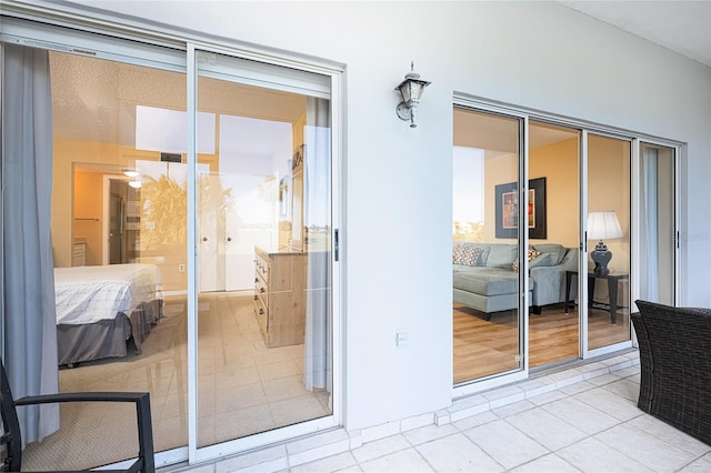 doorway to outside with light tile patterned flooring