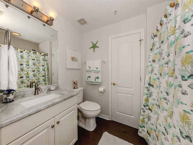 bathroom with hardwood / wood-style flooring, curtained shower, toilet, and vanity