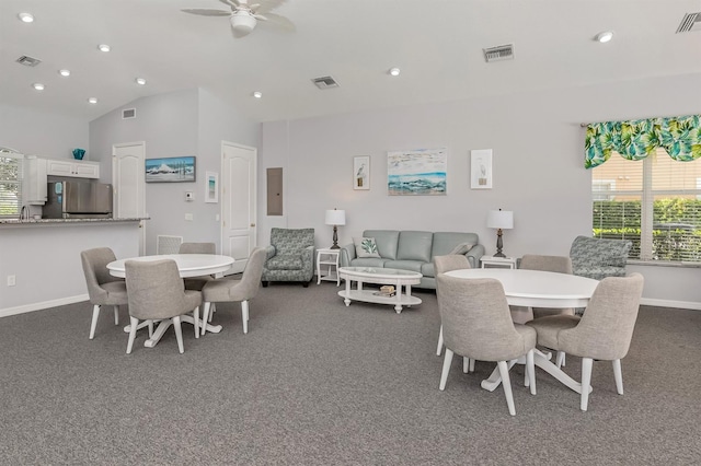 carpeted dining space featuring sink, ceiling fan, electric panel, and vaulted ceiling