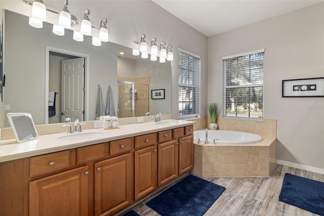 bathroom featuring hardwood / wood-style floors, independent shower and bath, and vanity