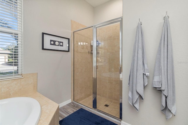 bathroom with hardwood / wood-style flooring and plus walk in shower