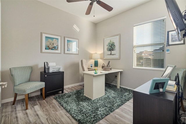 office space featuring ceiling fan, baseboards, and wood finished floors