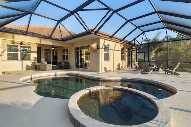 view of pool with a ceiling fan, a patio, glass enclosure, an outdoor hangout area, and a pool with connected hot tub