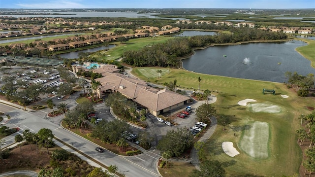 drone / aerial view featuring view of golf course and a water view