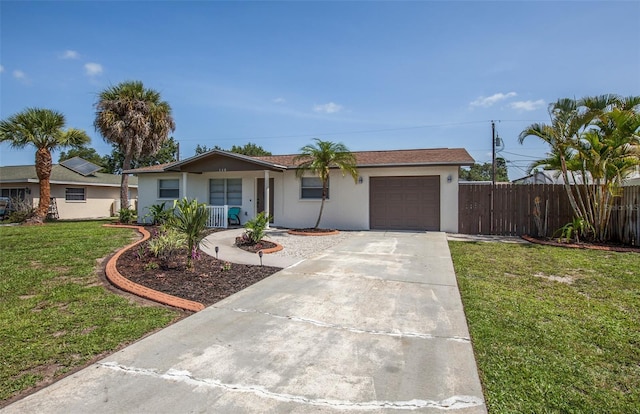 ranch-style home featuring a garage and a front yard